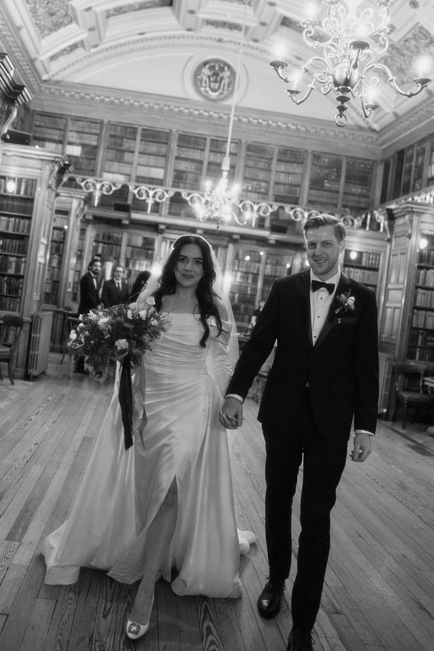 Bride and groom walking out through the New Library after their wedding ceremony at the Royal College of Physicians of Edinburgh